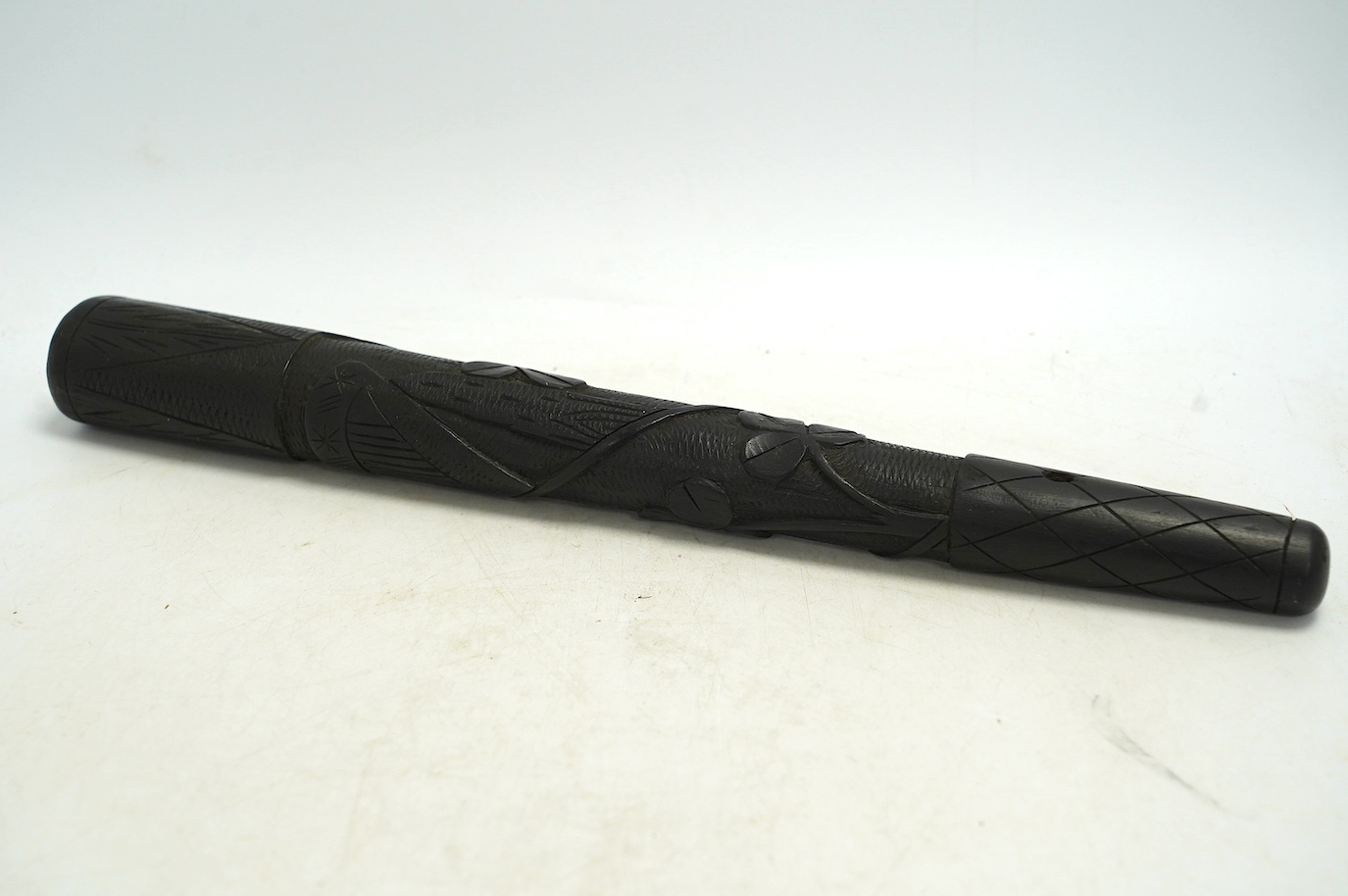 A late 19th/early 20th century Irish bog oak truncheon, carved with a harp and clovers, 37cm in length. Condition - good